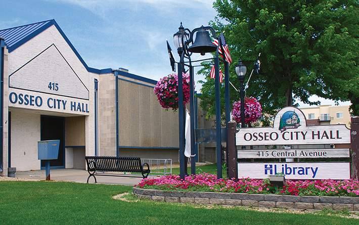 photograph of the Osseo City Hall, a white building with a blue roof