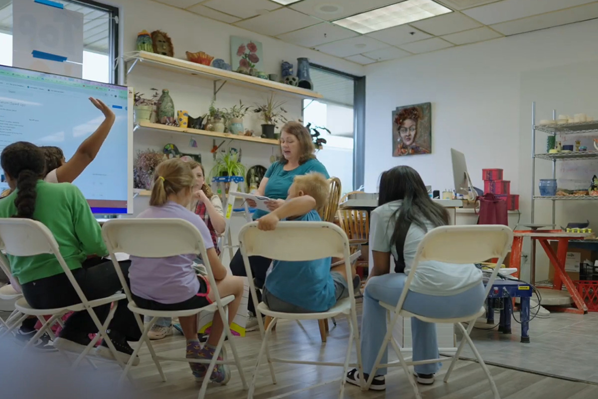 Katie Ross, founder of The Arts Creative, teaching a class of young people.