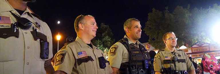Four uniformed deputies at the Minnesota State Fair at night. 