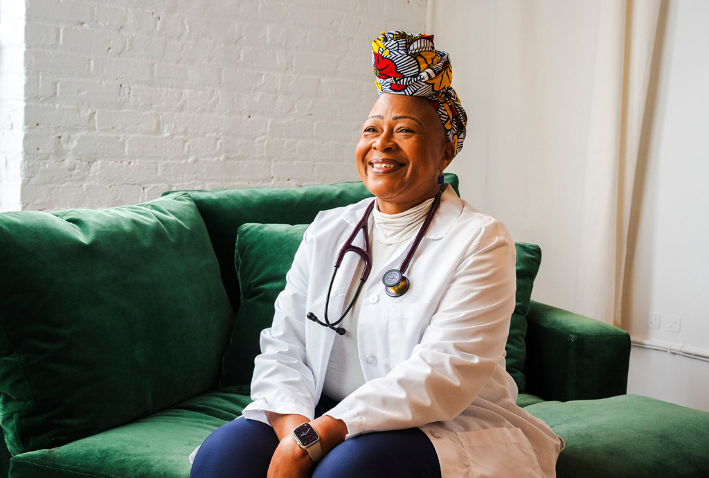 Woman smiling and wearing a stethascope