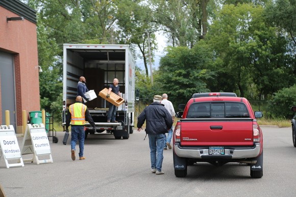 homeowners dropping off building materials to a donation truck
