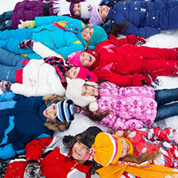 group of children laying in the snow