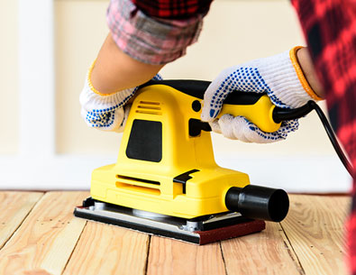 someone using a sander on the floor