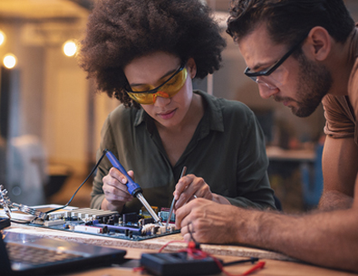 Two people repairing electronic device