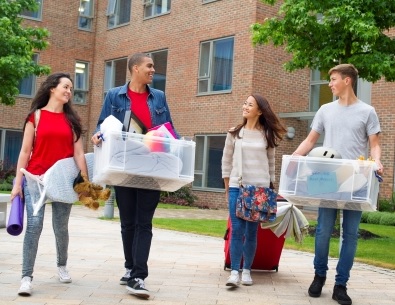 Four college students moving in to their dorm