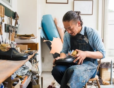 Cobbler repairing a shoe