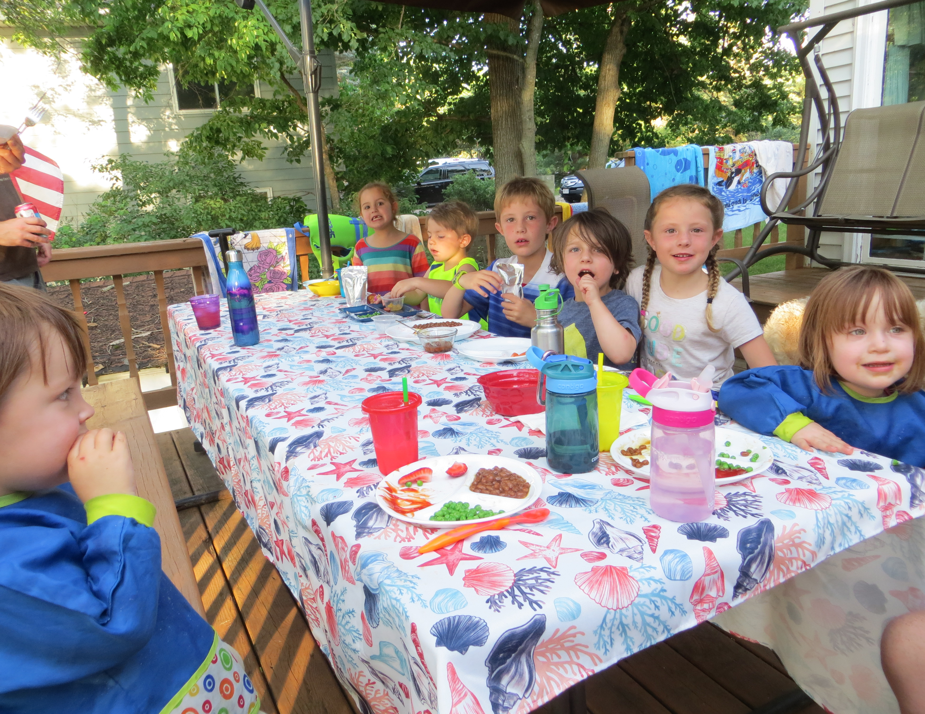 kids eating at a picnic table outside