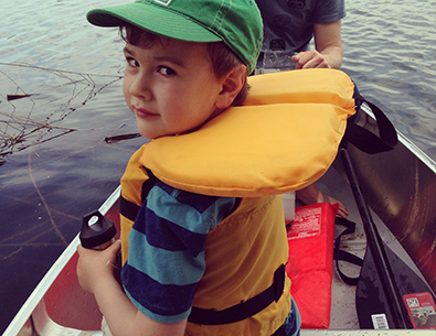 little boy in a lifejacket in a boat