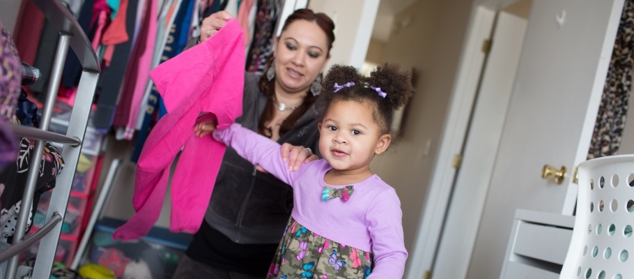 Mom and daughter choosing clothing to donate