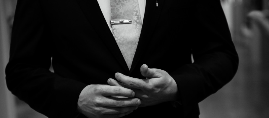 Groom wearing thrifted tie clip at wedding