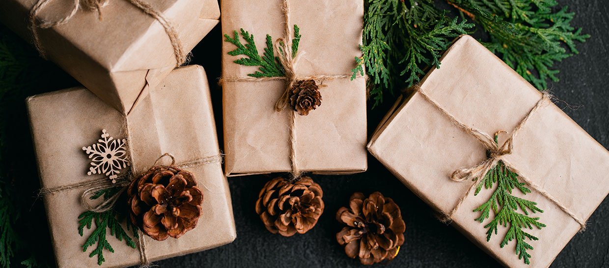 Brown paper wrapped gifts with natural items instead of bows