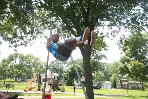 Boy swinging at playground
