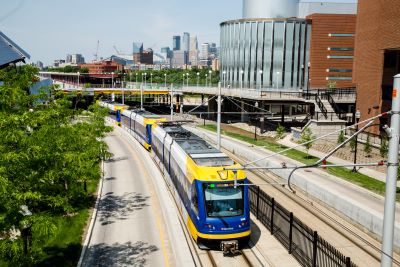 Overhead photo of light rail train with downtown Minneapolis in background