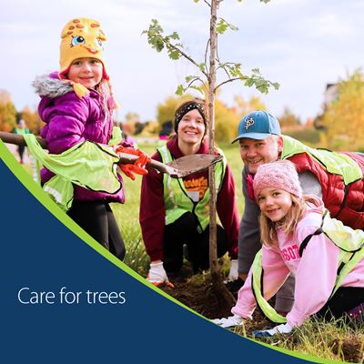 Photo of a mom and dad with two young girls with their hands on the dirt around a newly planted tree with text that says care for trees