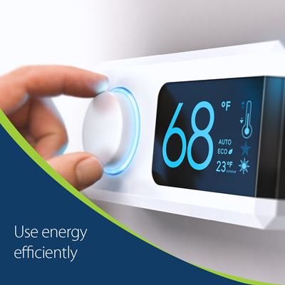 Close up of a person's hand adjusting a thermostat with text that says use energy efficiently