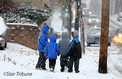 Kids walking on sidewalk in snow