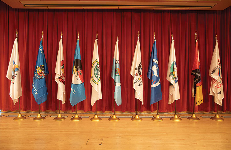 multiple different types of flags in a room inside