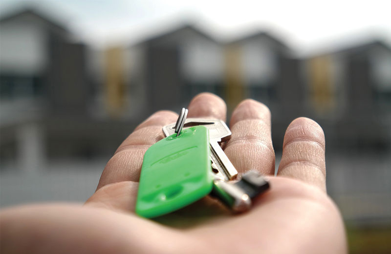 hand outstretched holding a house key
