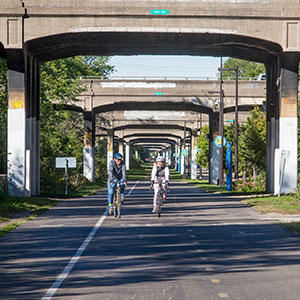 greenway bridge with people on bikes