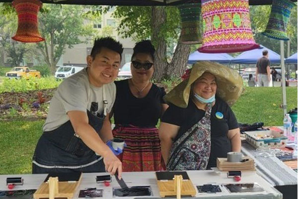 adults setting up a craft station outside