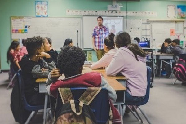 kids in classroom listening to the teacher