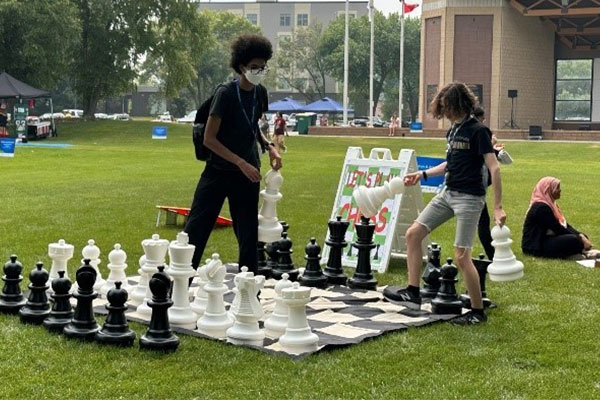 kids playing large chess game outside