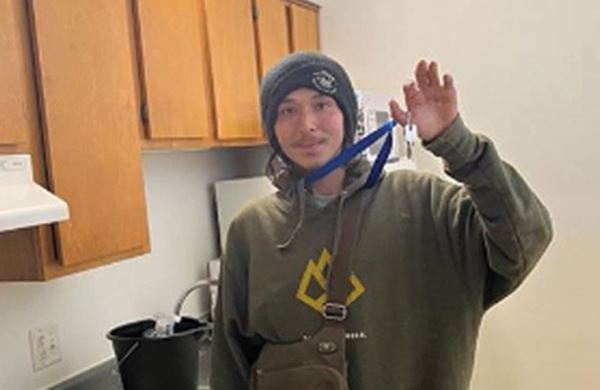 man waving in his new apartment