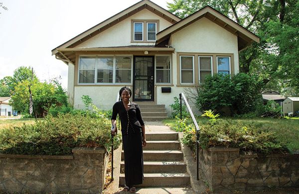 women standing in front of house