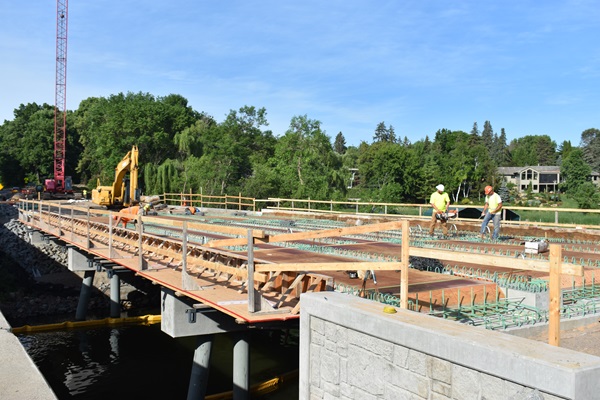Crew members on the new bridge to set rebar and pour concrete for the travel lanes, approaches and railings